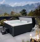 Grauer Outdoor-Whirlpool mit geöffneter Abdeckung vor Bergpanorama