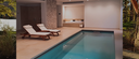 Innenpool mit zwei Liegen in einem modernen Wellnessraum