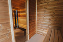 Vorraum der Round Cube Gartensauna mit Sitzbank und Glastür zum beleuchteten Saunaraum