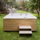 VIBES by USSPA Natura Whirlpool mit heller Holzverkleidung und Einstiegstreppe im Garten
